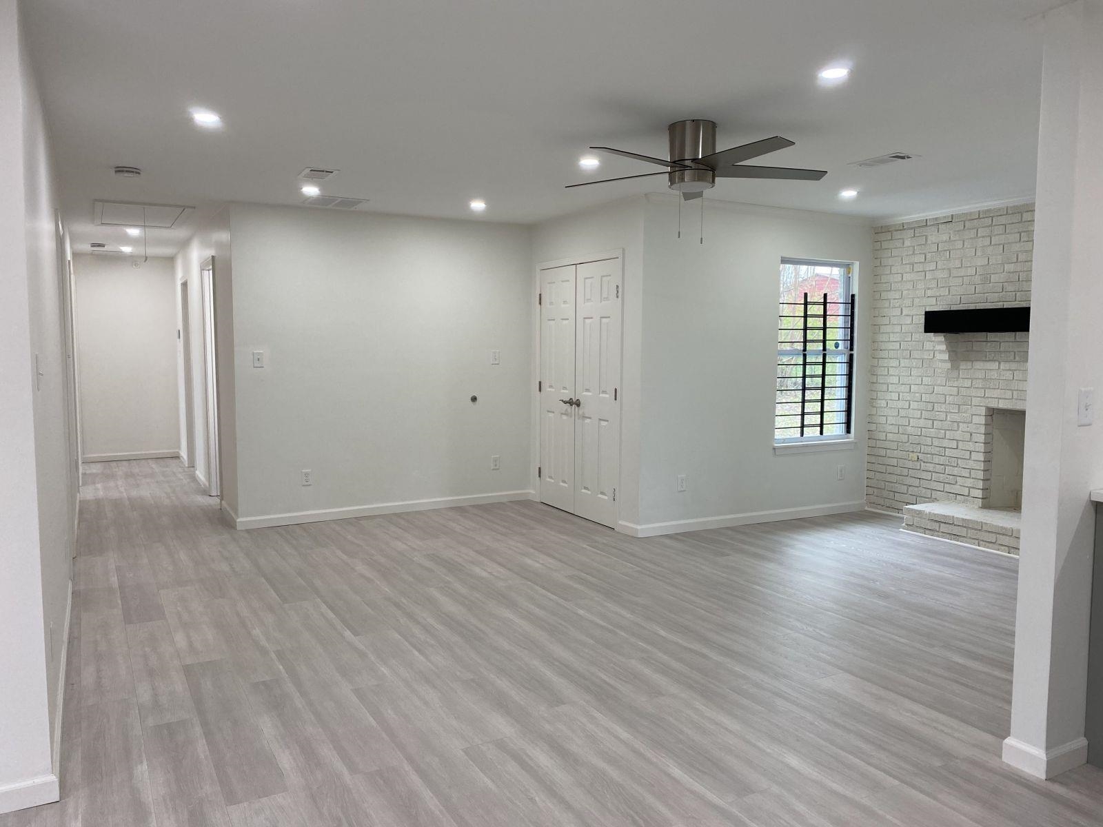 5089 Horn Lake Road Memphis, TN 38109 - Photo 11 of 23 an empty room with wooden floor and windows