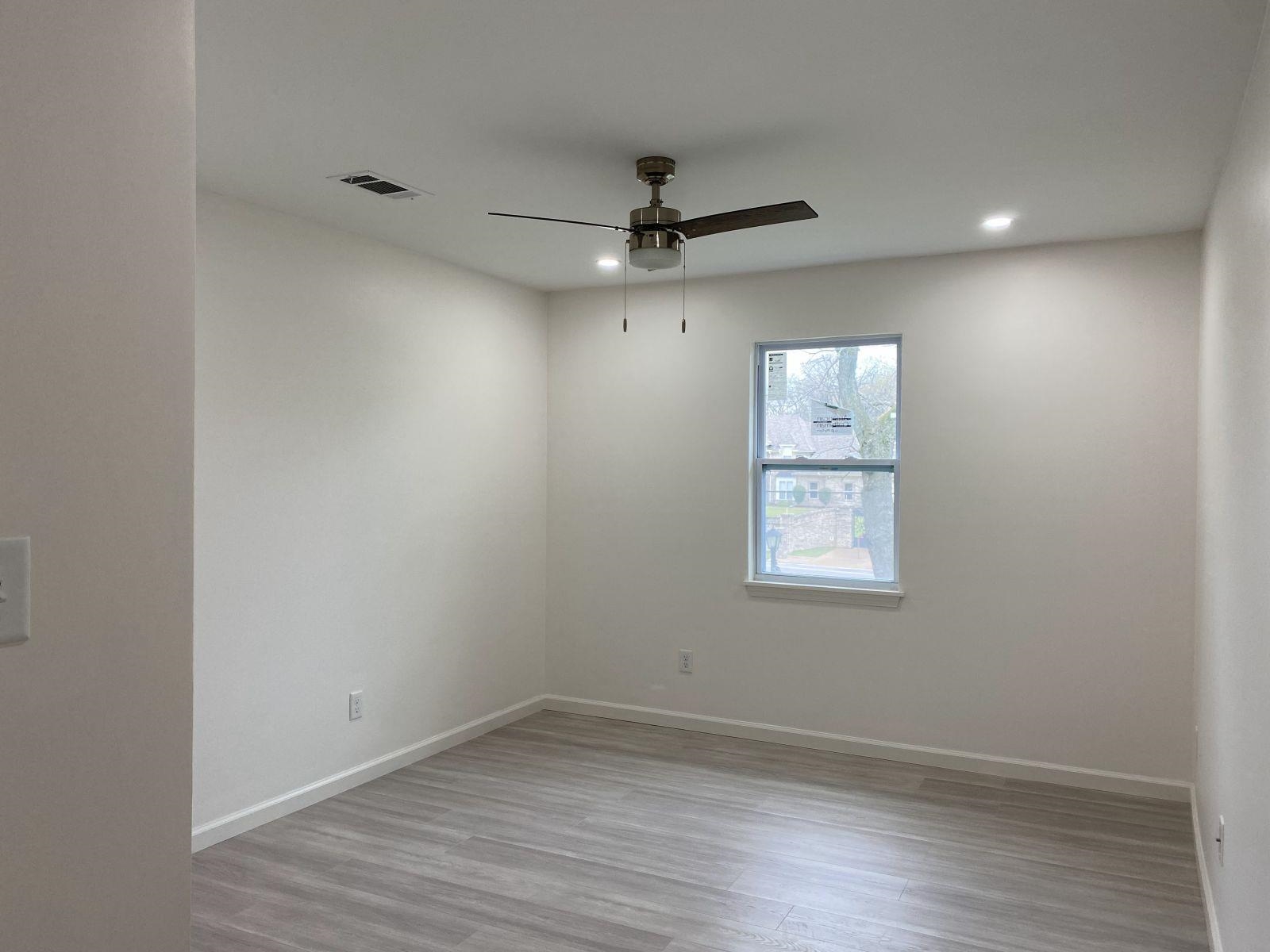 5089 Horn Lake Road Memphis, TN 38109 - Photo 12 of 23 an empty room with a window and a ceiling fan