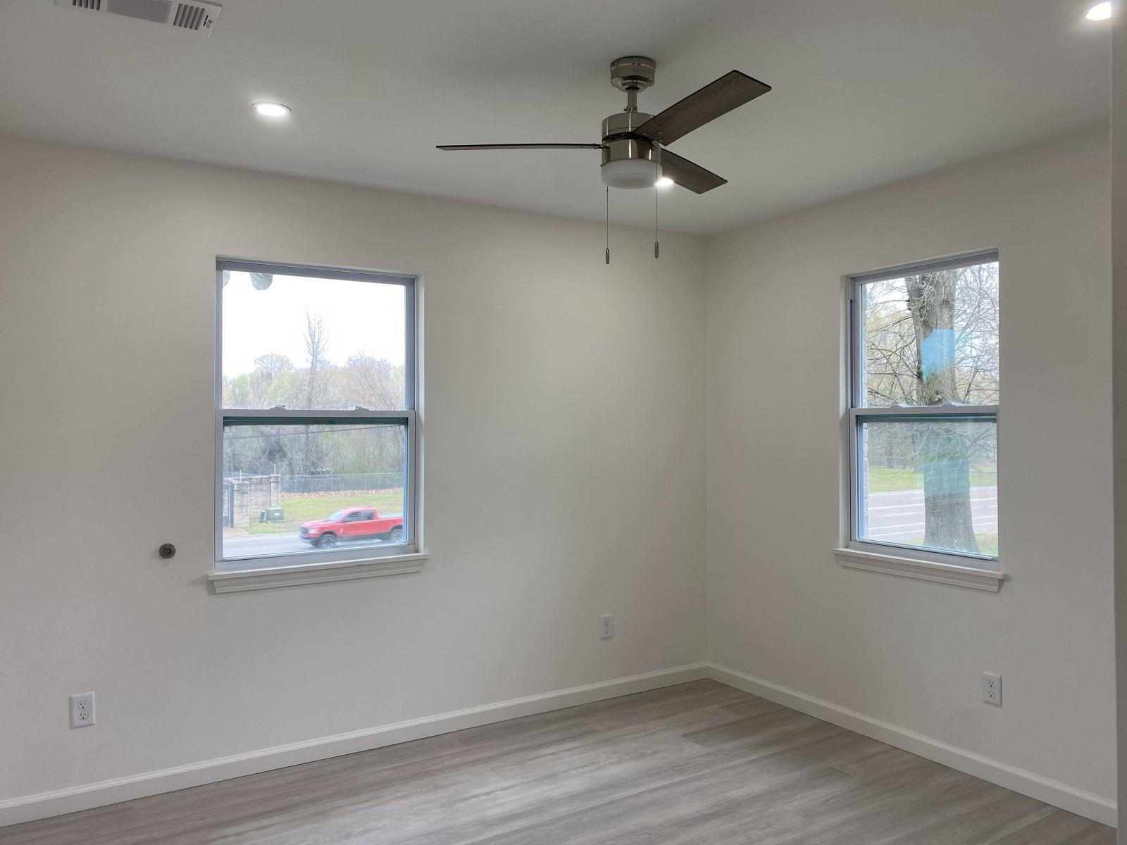 5089 Horn Lake Road Memphis, TN 38109 - Photo 14 of 23 an empty room with wooden floor and windows