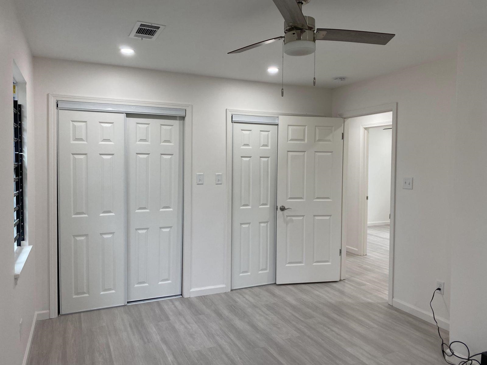 5089 Horn Lake Road Memphis, TN 38109 - Photo 16 of 23 an empty room with wooden floor a ceiling fan and entryway