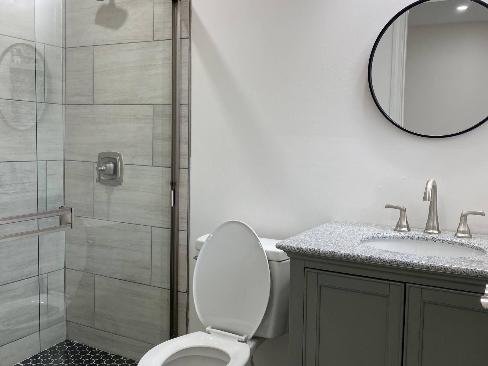 5089 Horn Lake Road Memphis, TN 38109 - Photo 17 of 23 a bathroom with a sink mirror toilet and shower