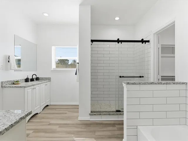 a bathroom with a sink a mirror and a shower
