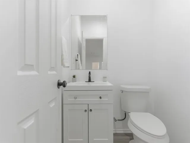 a bathroom with a toilet a sink and mirror