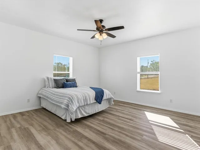 a spacious bedroom with a bed and window