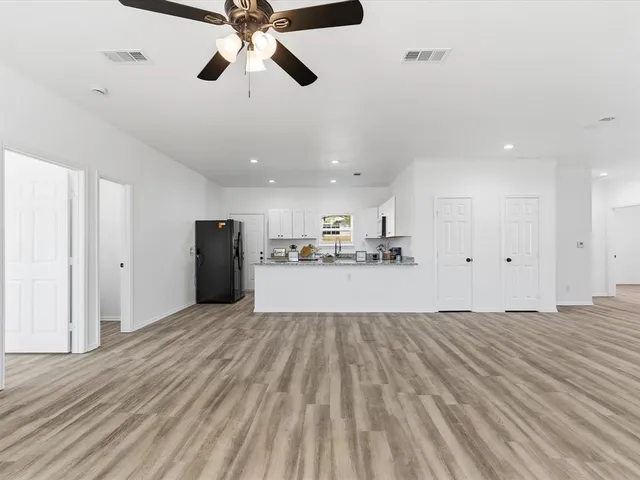 a view of a kitchen with a sink and refrigerator