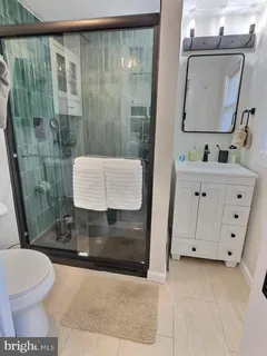 a bathroom with a toilet a sink and shower