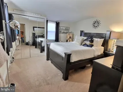 a bed room with a bed and a chair