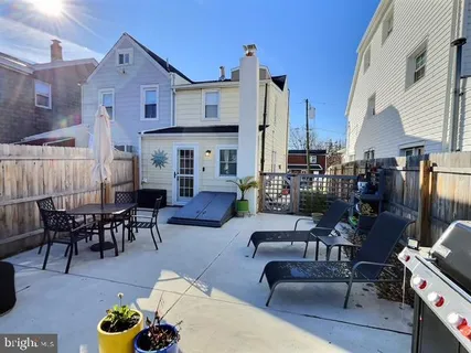 a living room with furniture a chandelier and a dining table