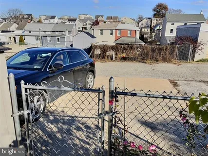 a view of a house with wooden fence