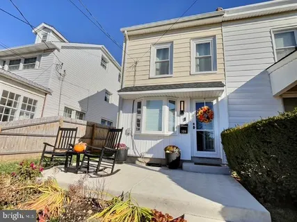 a view of a house with a patio and a yard