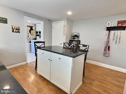 a view of kitchen island with wooden floor