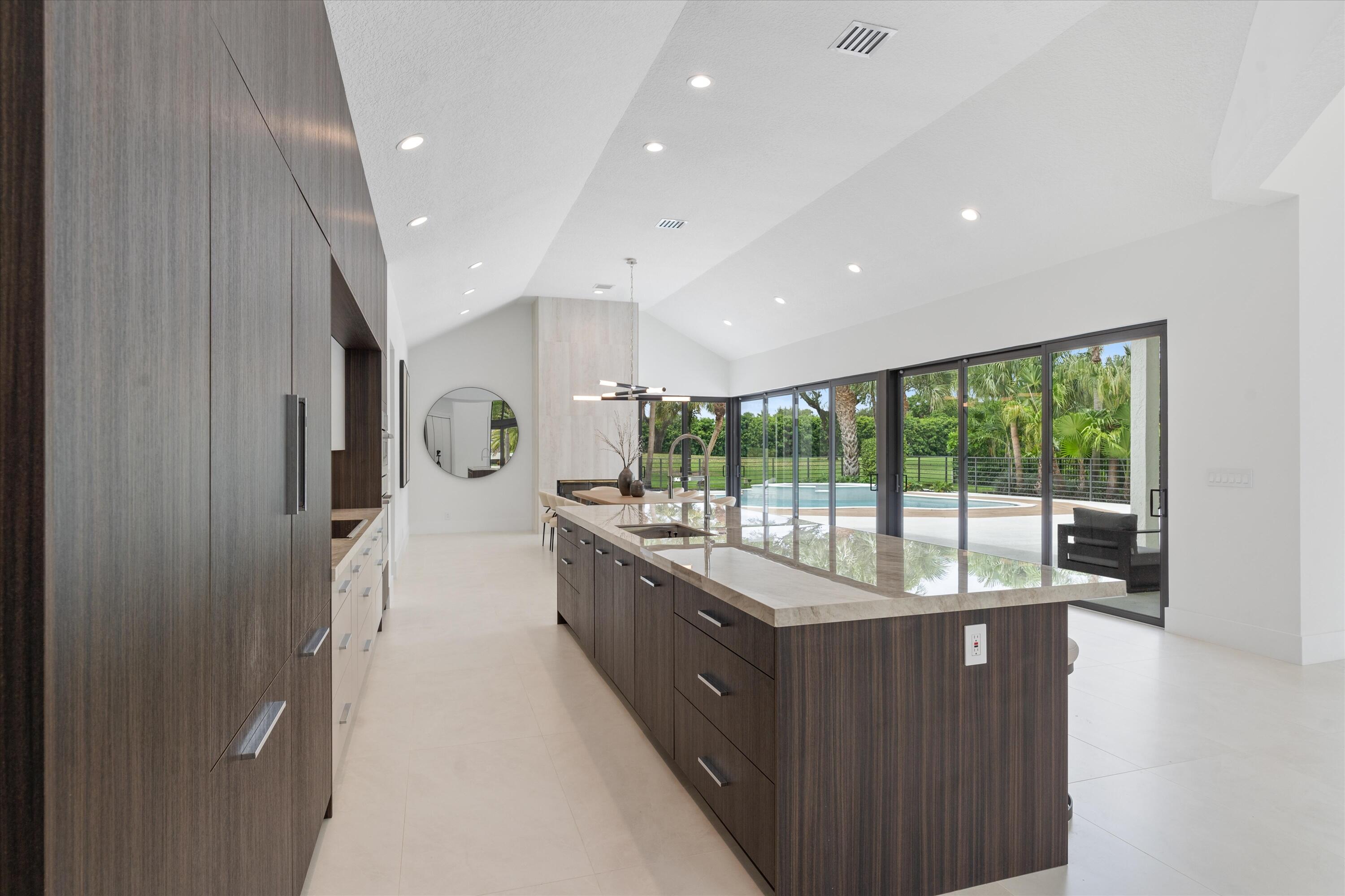 4816 Bocaire Boulevard Boca Raton, FL 33487 - Photo 15 of 61 a large kitchen with a large counter top and stainless steel appliances