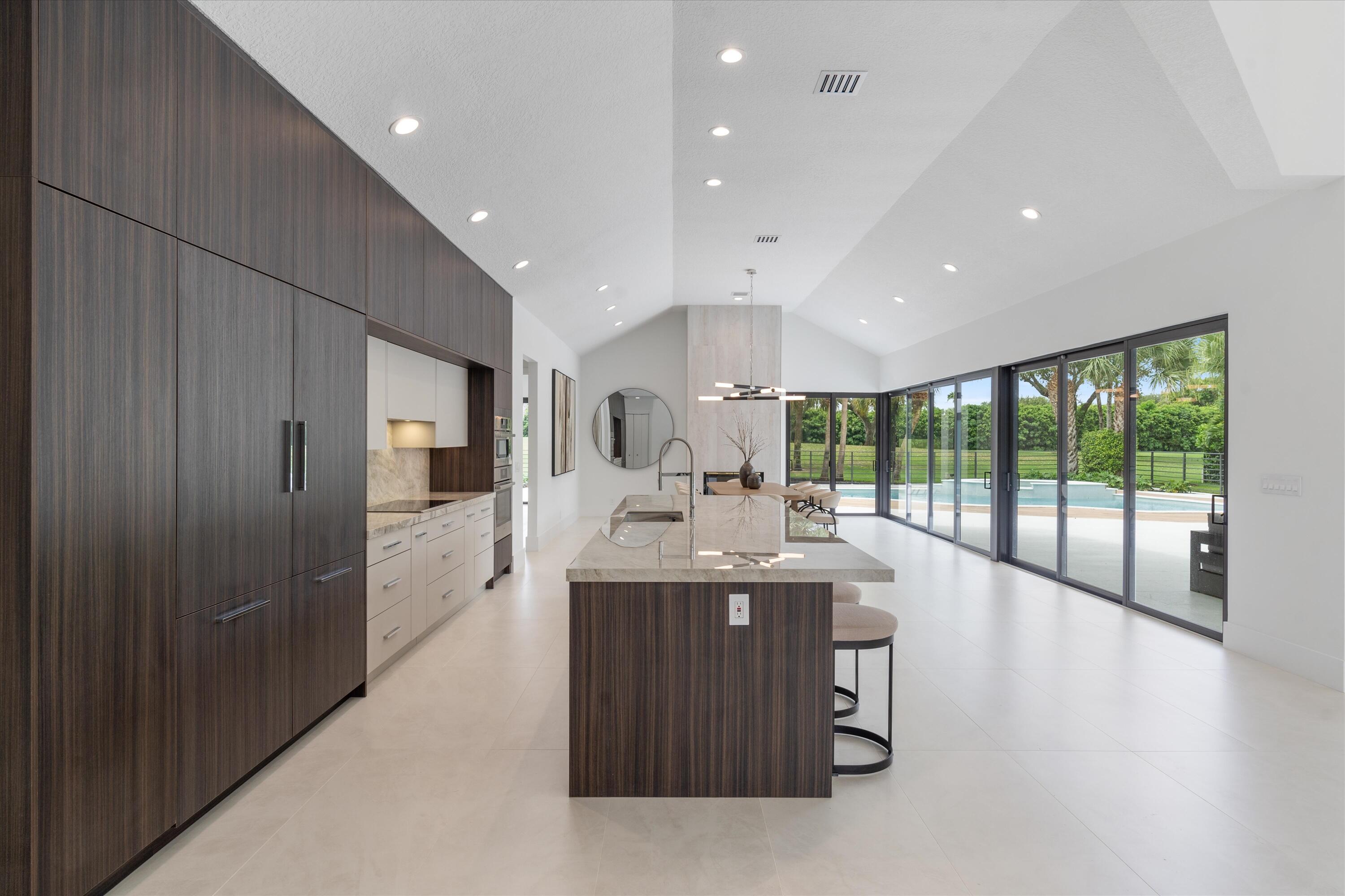 4816 Bocaire Boulevard Boca Raton, FL 33487 - Photo 16 of 61 a kitchen with stainless steel appliances granite countertop a sink and cabinets