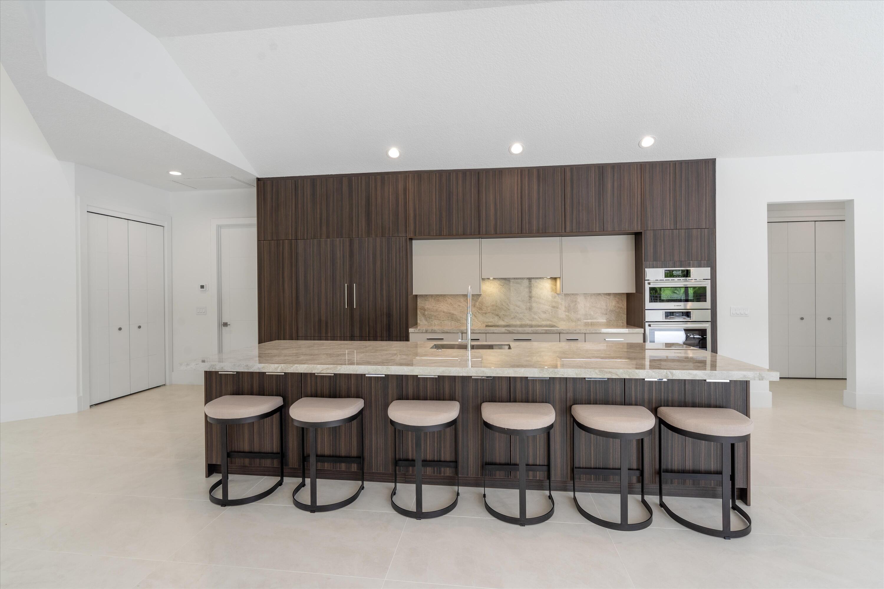 4816 Bocaire Boulevard Boca Raton, FL 33487 - Photo 17 of 61 a kitchen with a table and chairs in it