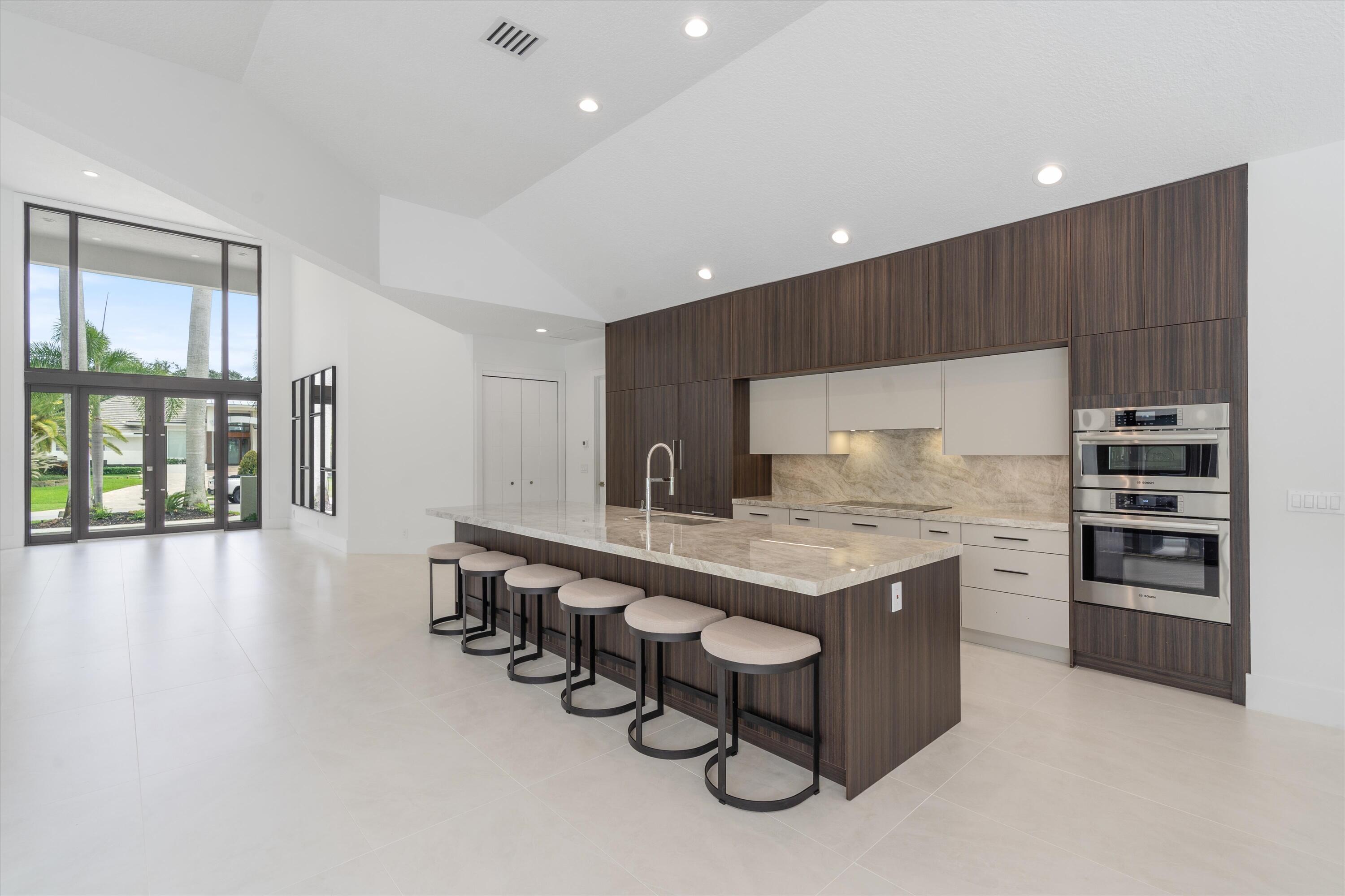4816 Bocaire Boulevard Boca Raton, FL 33487 - Photo 18 of 61 a kitchen with stainless steel appliances a sink a stove and a refrigerator