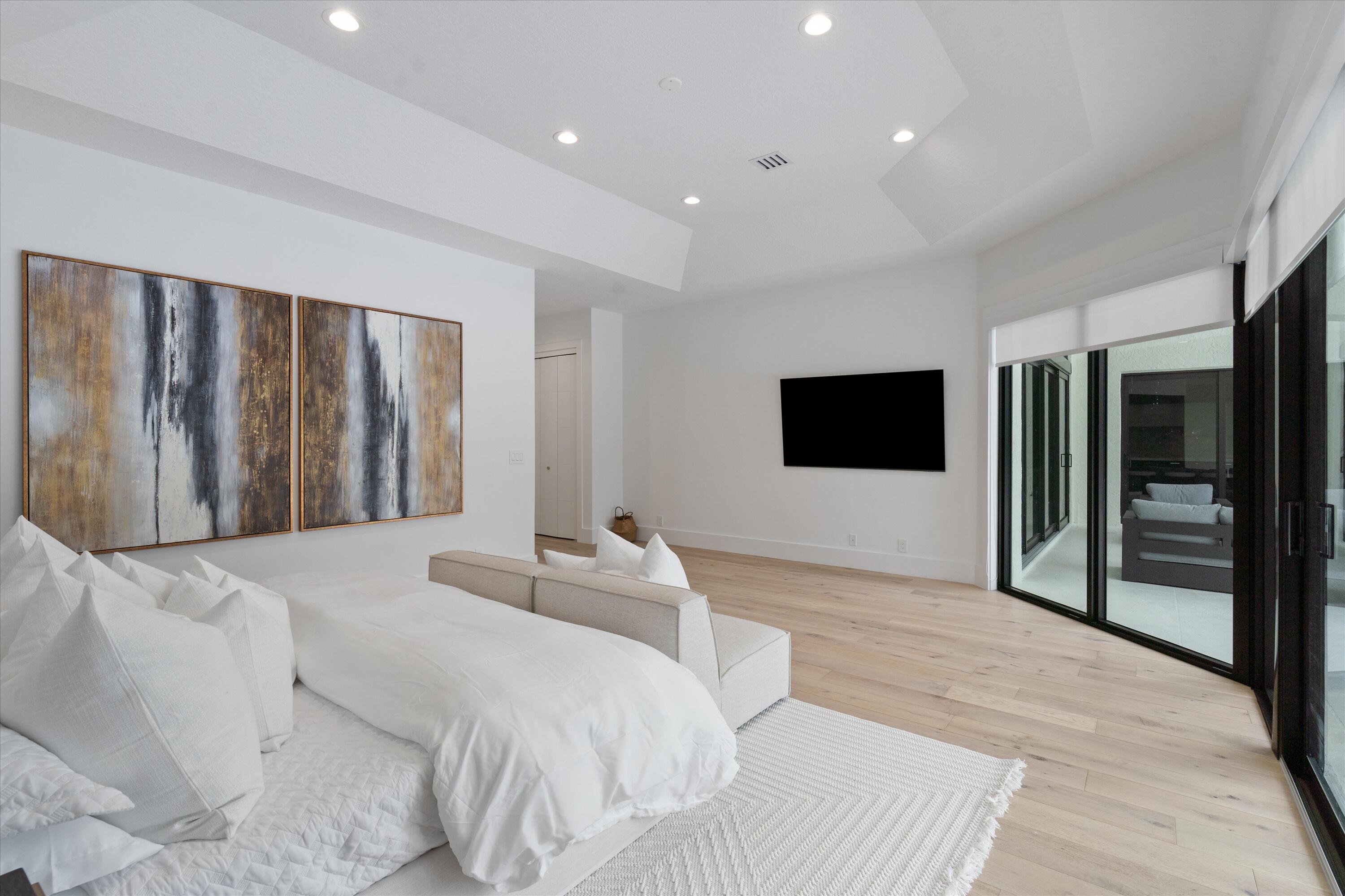 4816 Bocaire Boulevard Boca Raton, FL 33487 - Photo 29 of 61 a bedroom with a bed and a flat screen tv