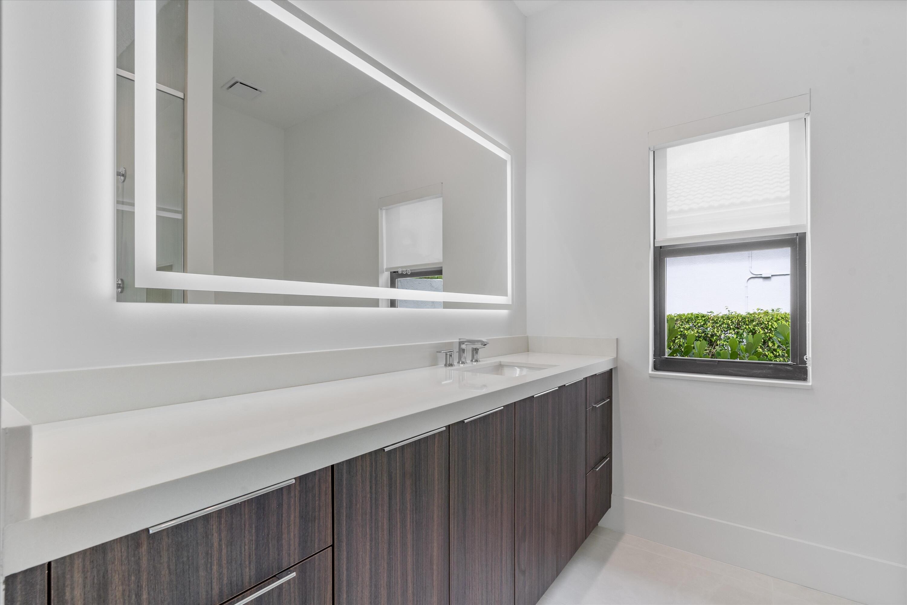 4816 Bocaire Boulevard Boca Raton, FL 33487 - Photo 31 of 61 a bathroom with a sink and a mirror