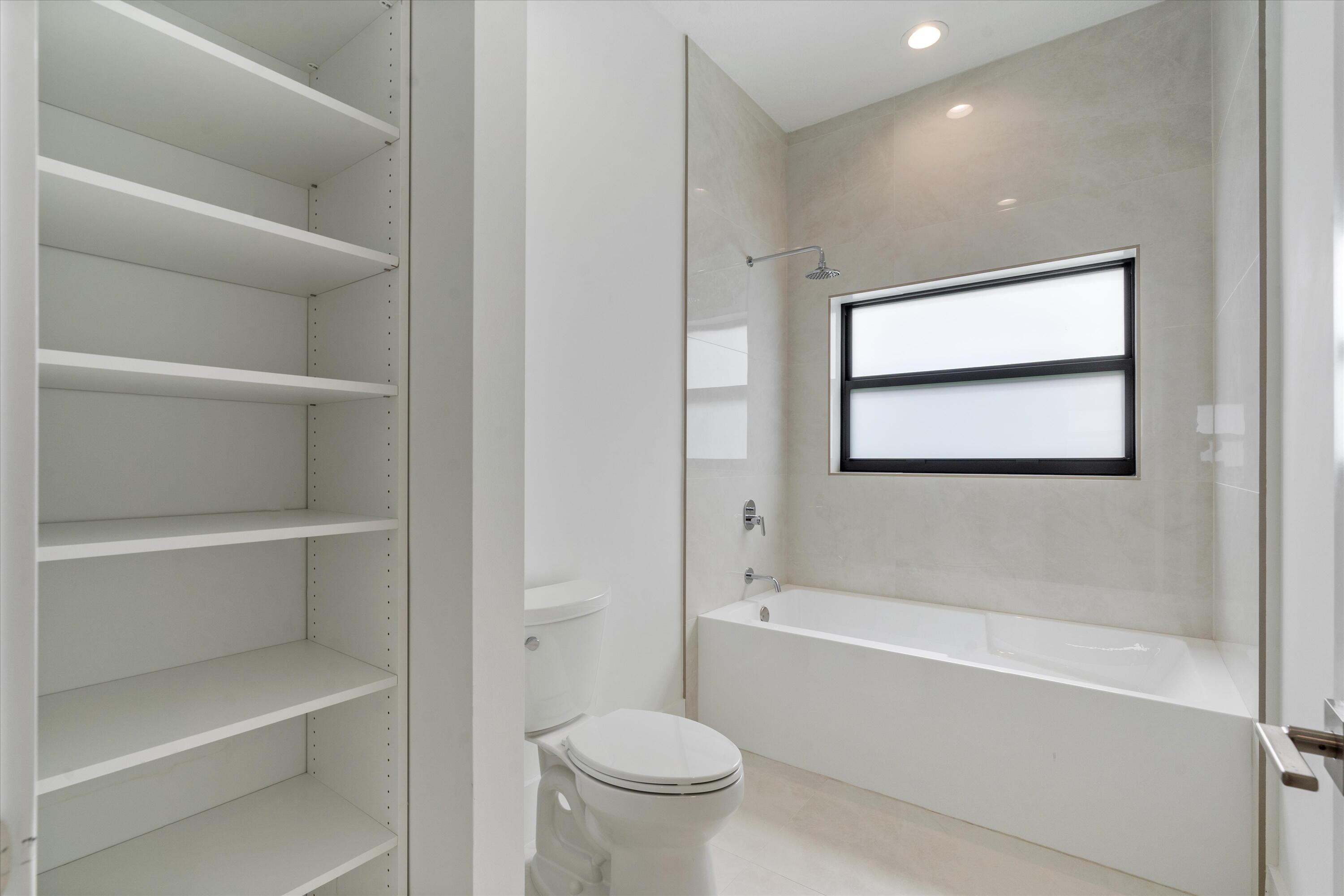 4816 Bocaire Boulevard Boca Raton, FL 33487 - Photo 36 of 61 a bathroom with a toilet and a bathtub