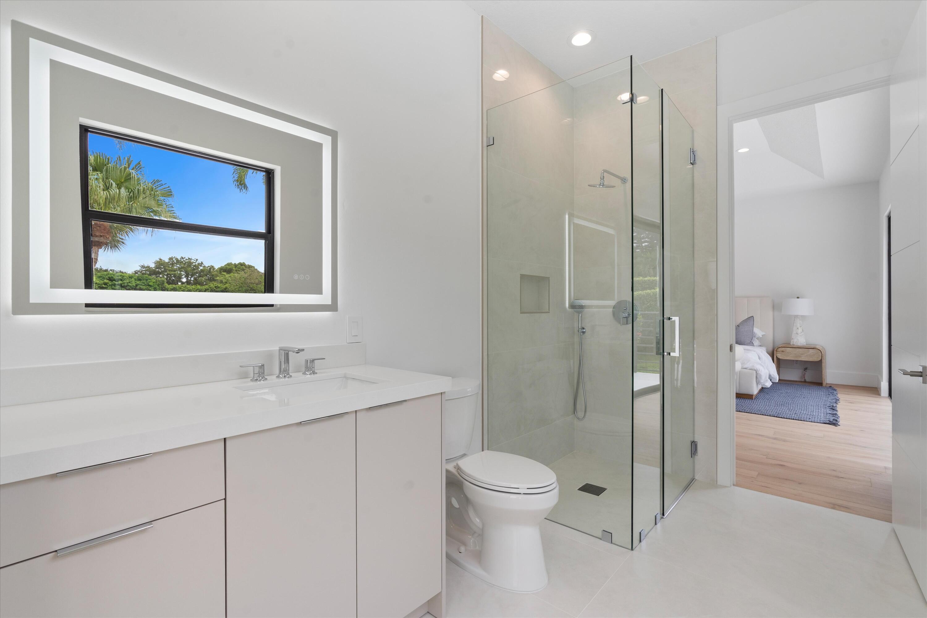 4816 Bocaire Boulevard Boca Raton, FL 33487 - Photo 45 of 61 a bathroom with a granite countertop sink a toilet and shower