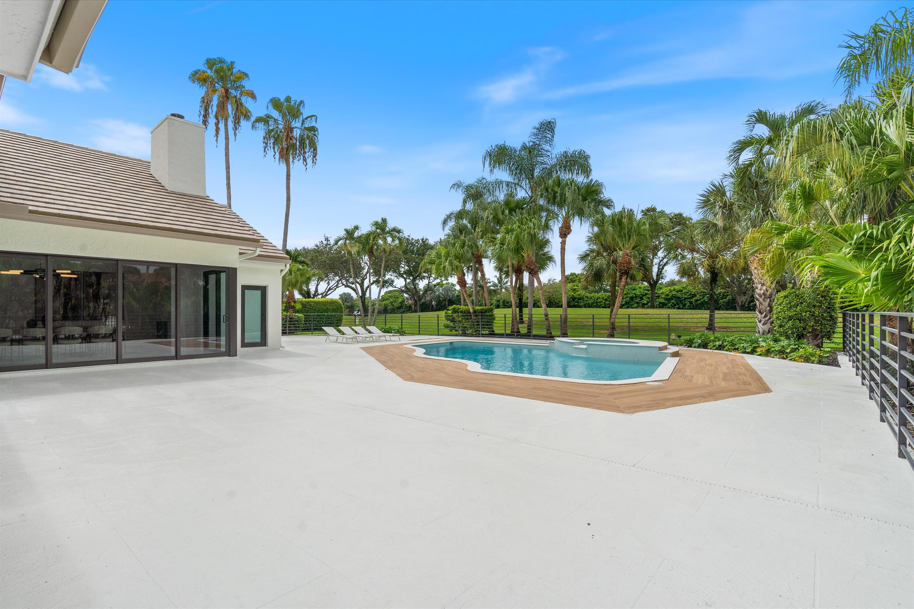 4816 Bocaire Boulevard Boca Raton, FL 33487 - Photo 51 of 61 a view of a house with a yard and a garage