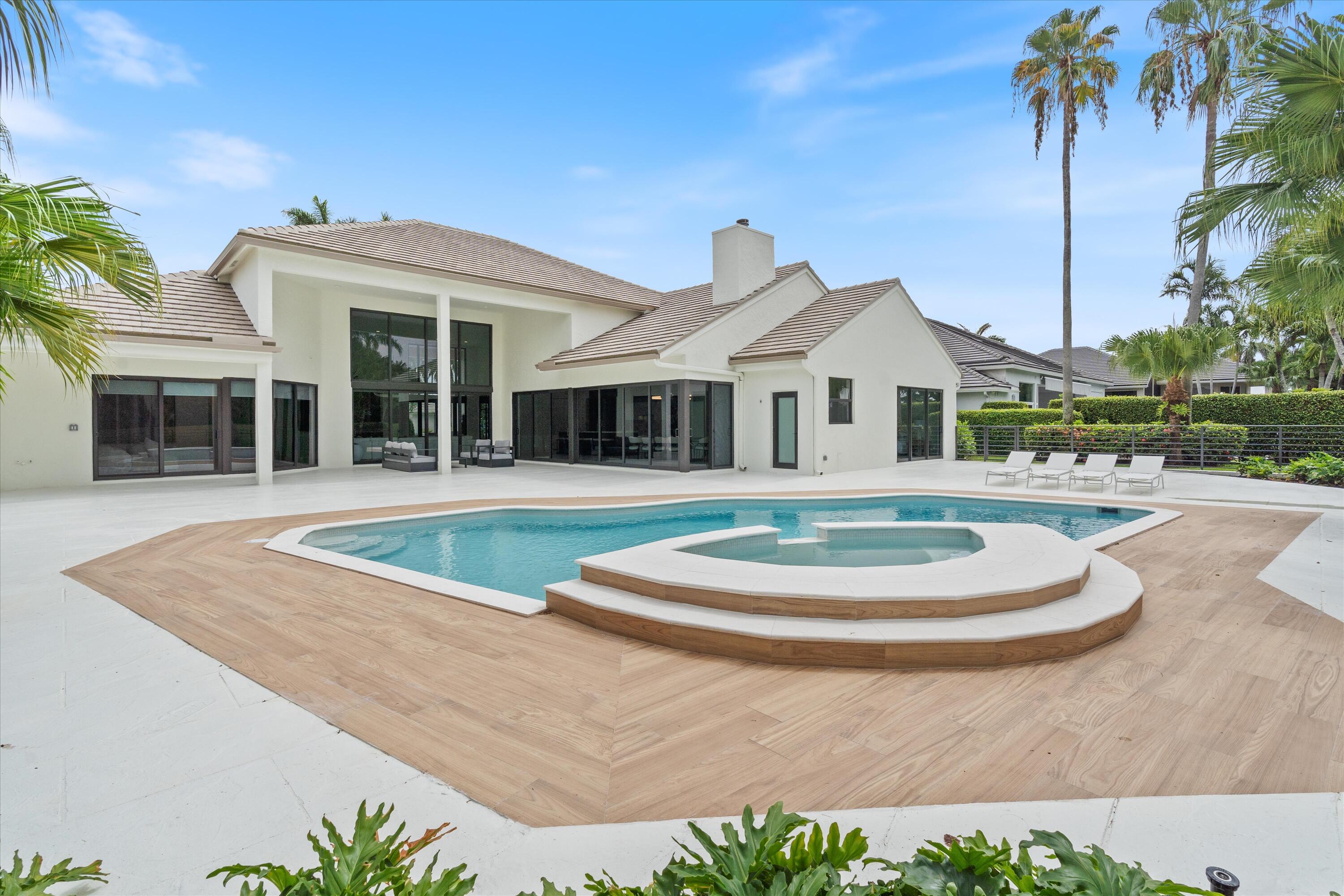 4816 Bocaire Boulevard Boca Raton, FL 33487 - Photo 52 of 61 a front view of a house with a garden and trees