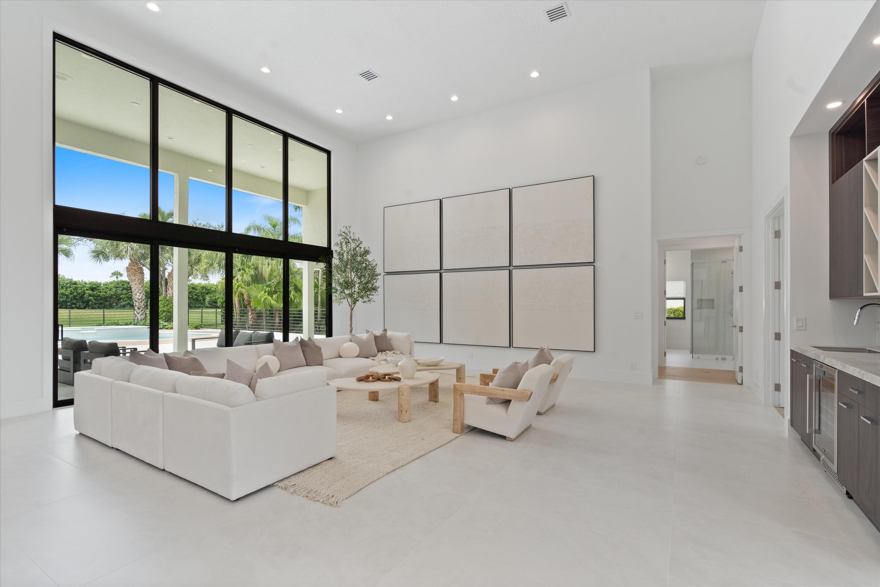 4816 Bocaire Boulevard Boca Raton, FL 33487 - Photo 7 of 61 a living room with furniture large window and a large mirror