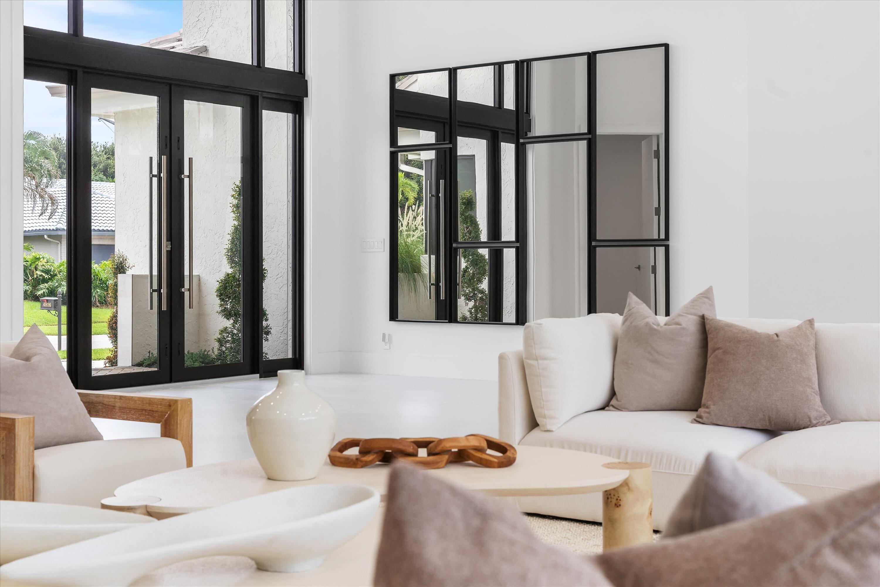 4816 Bocaire Boulevard Boca Raton, FL 33487 - Photo 8 of 61 a living room with furniture and large windows with outer view