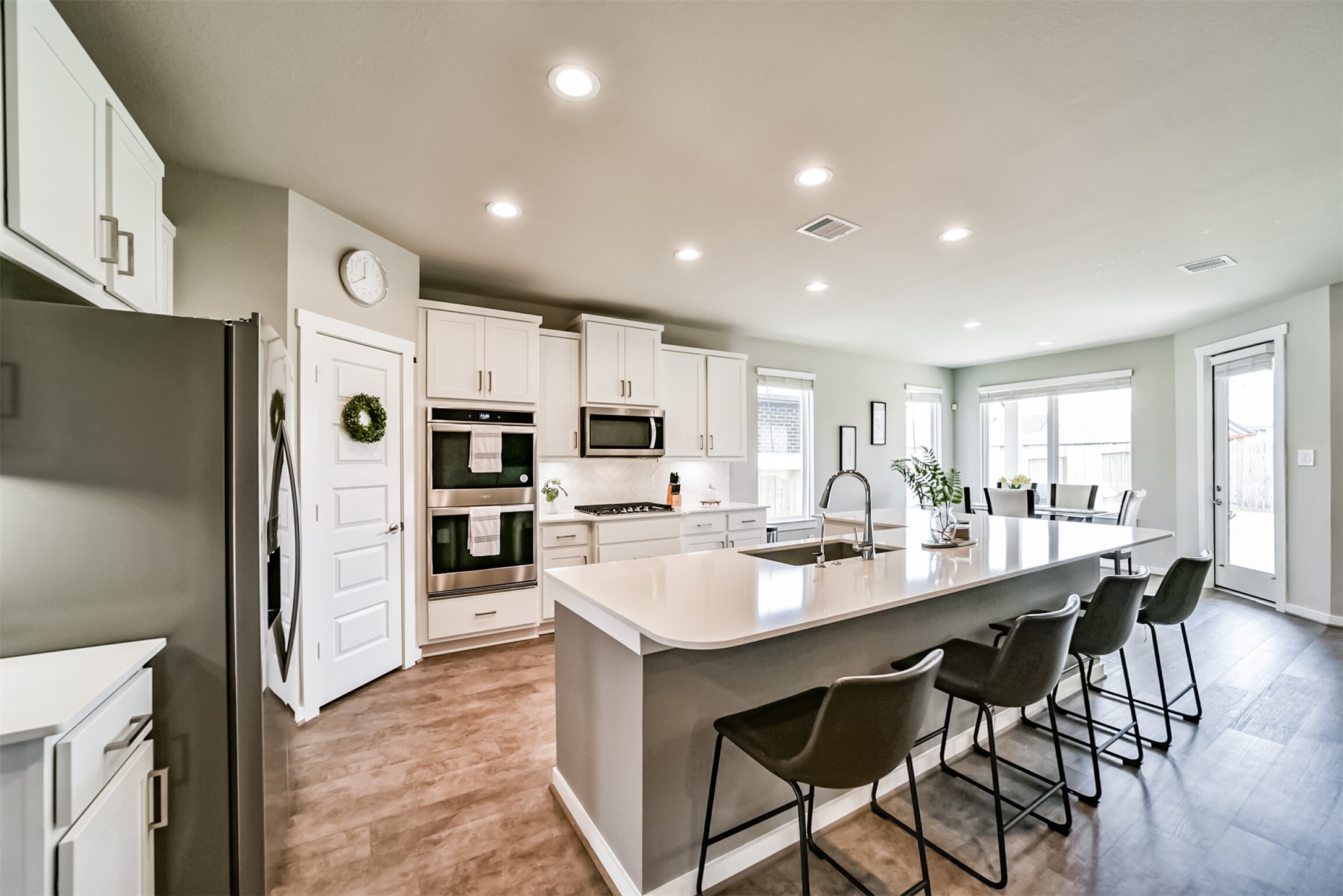 29510 Red Rocks Pk Drive Katy, TX 77494 - Photo 12 of 31 a kitchen with stainless steel appliances granite countertop a table chairs refrigerator and cabinets