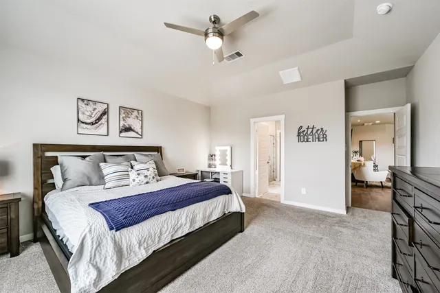 a bedroom with bed and a chandelier