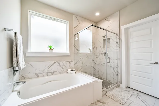 a bathroom with a bathtub and a shower