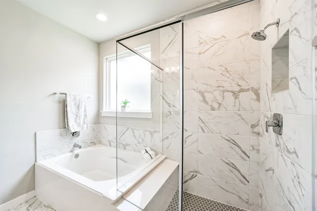 a bathroom with a bathtub and shower