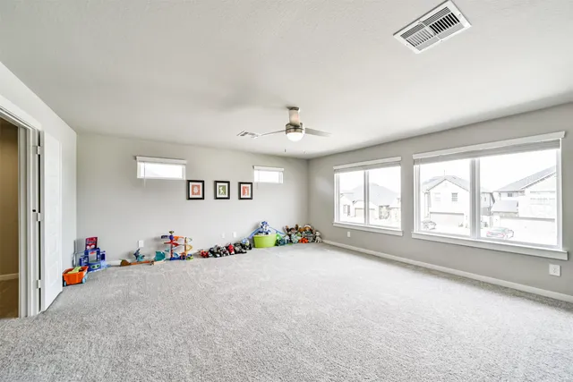 an empty room with toys and windows