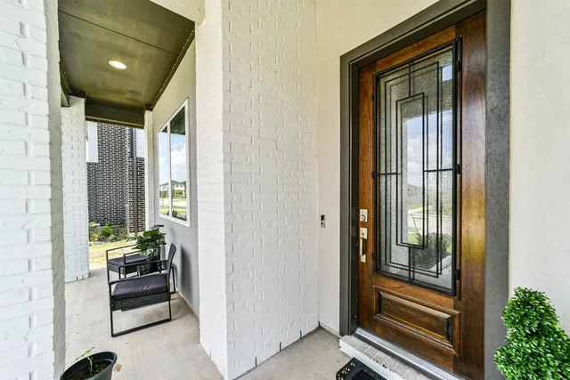 a view of a hallway and a livingroom with furniture