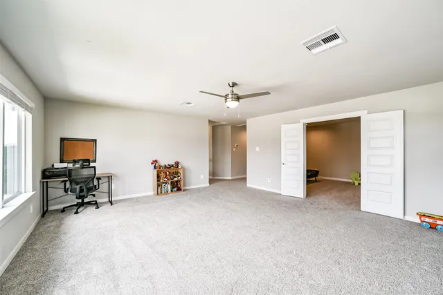 a view of a livingroom with workspace and a window