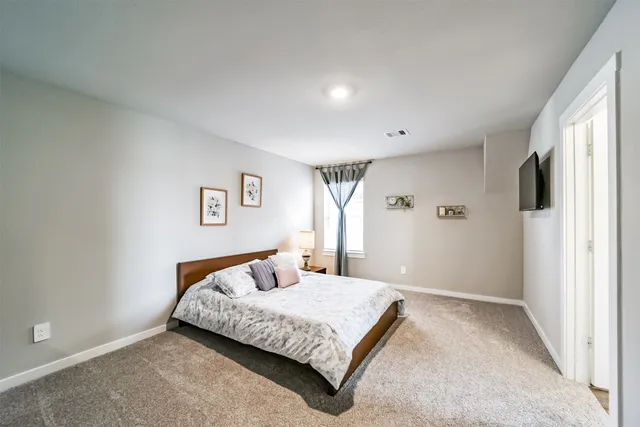 a bedroom with furniture and a window