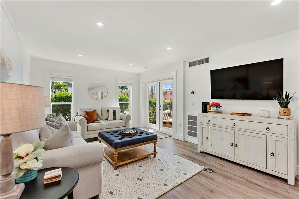 7003 Sunset Way, Unit 4 St. Pete Beach, FL 33706 - Photo 11 of 21 a living room with furniture and a flat screen tv