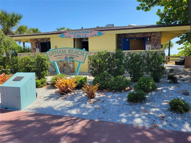 a view of a chair and table in the backyard