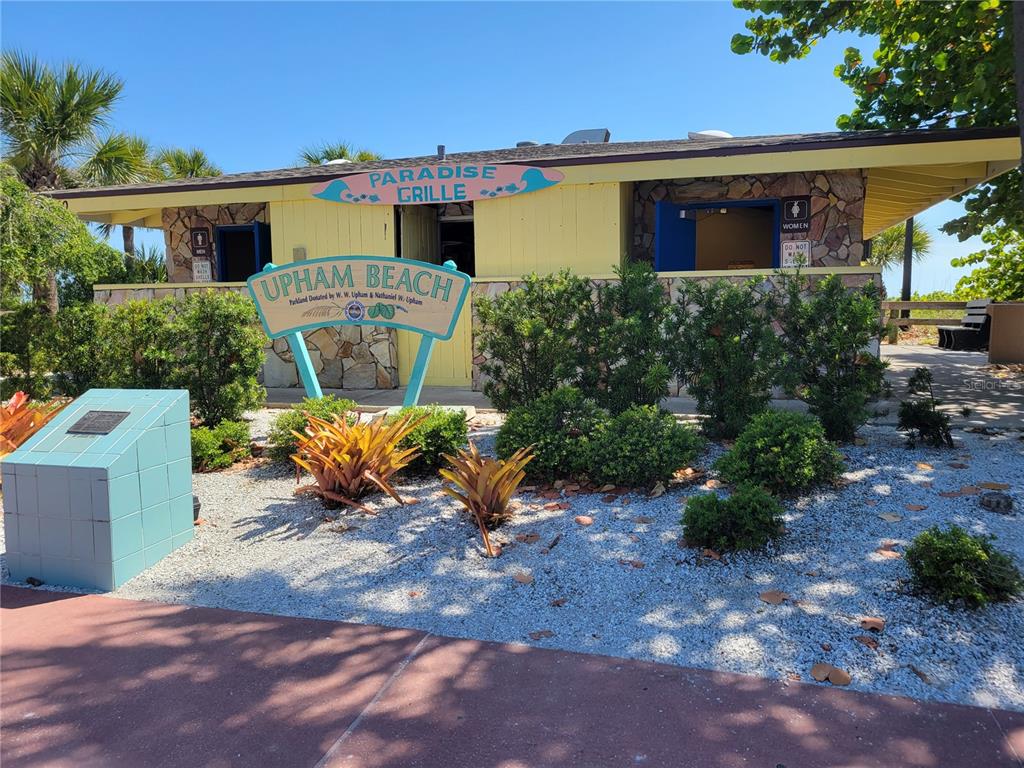 7003 Sunset Way, Unit 4 St. Pete Beach, FL 33706 - Photo 18 of 21 a view of a chair and table in the backyard