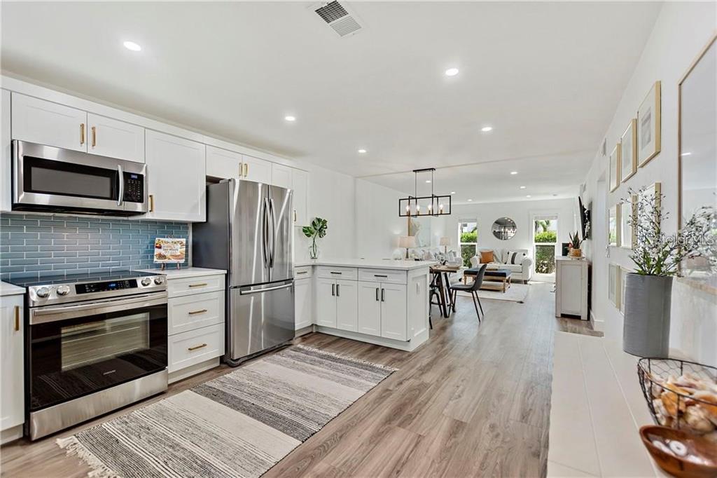 7003 Sunset Way, Unit 4 St. Pete Beach, FL 33706 - Photo 5 of 21 a kitchen with a sink stainless steel appliances and cabinets