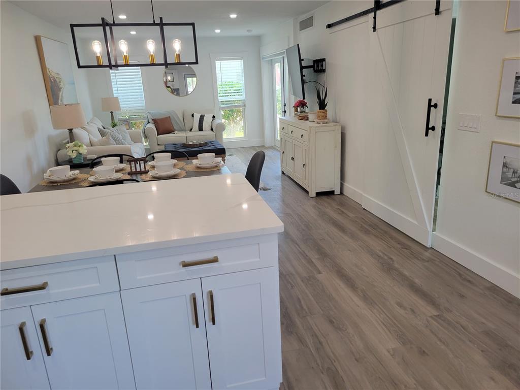 7003 Sunset Way, Unit 4 St. Pete Beach, FL 33706 - Photo 6 of 21 a room with lot of cabinets and wooden floor