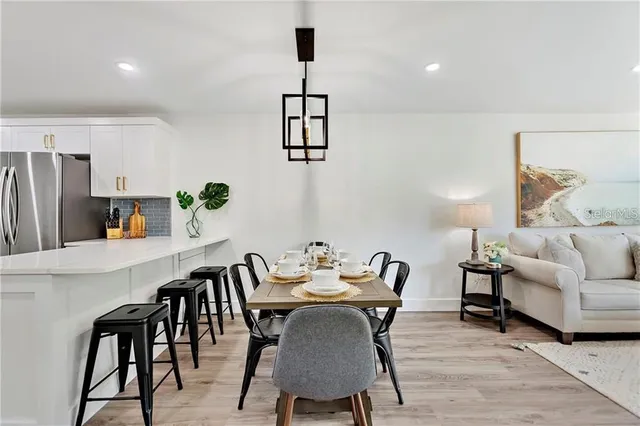 a view of a dining room with furniture and wooden floor