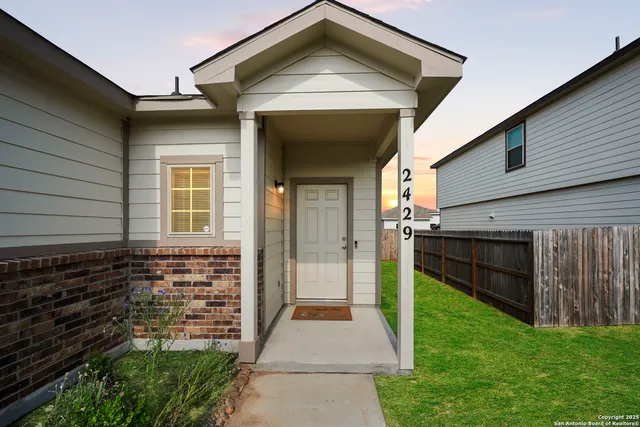 a view of house with backyard