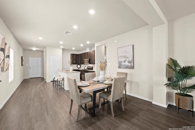 a view of a dining room with furniture and wooden floor