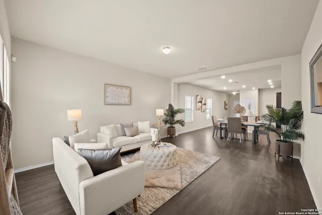 a living room with furniture and wooden floor
