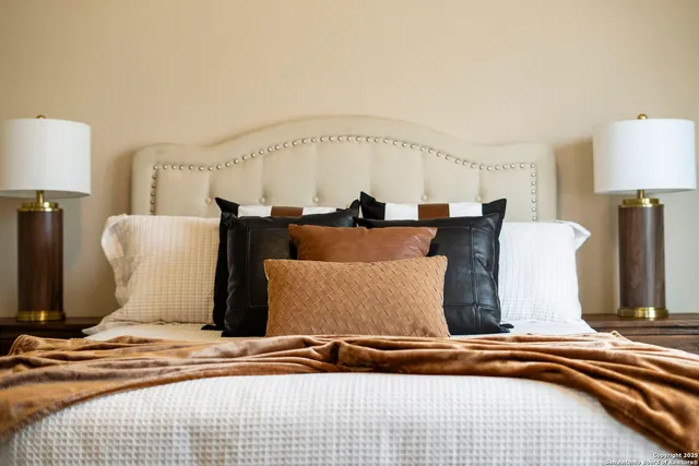 a bedroom with furniture and a large mirror