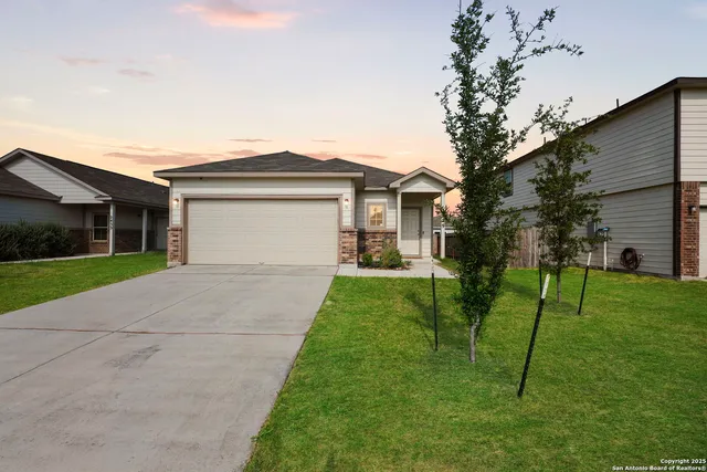 a front view of house with a garden