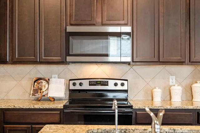 a stove top oven sitting inside of a kitchen