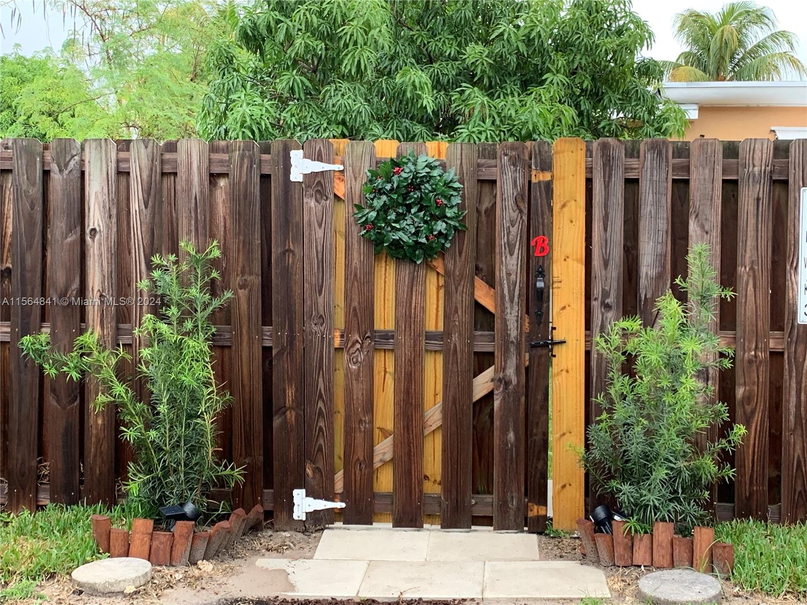 a view of a garden with wooden fence