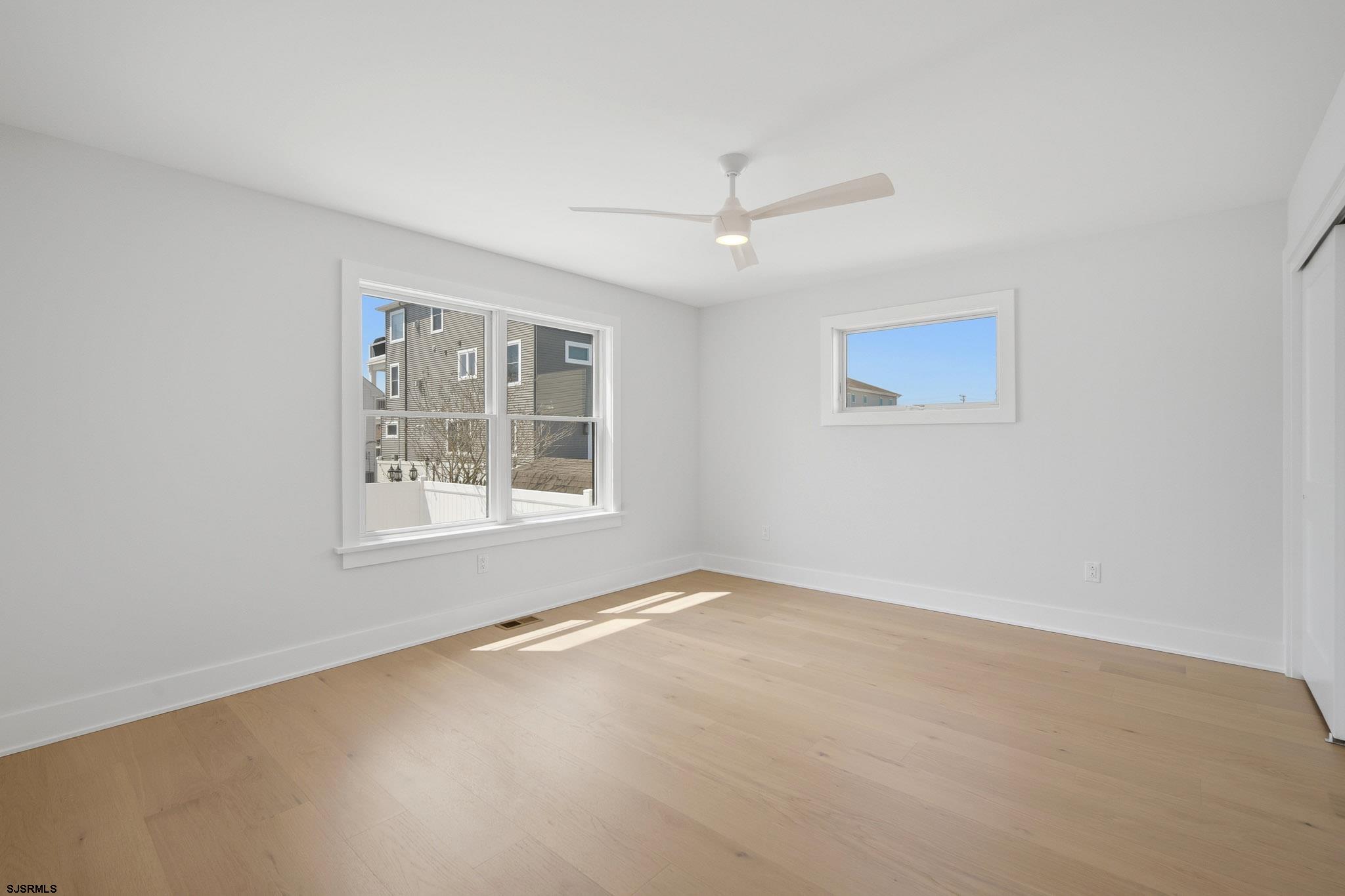 230 7th Street South Brigantine, NJ 08203 - Photo 19 of 87 an empty room with a window and ceiling fan
