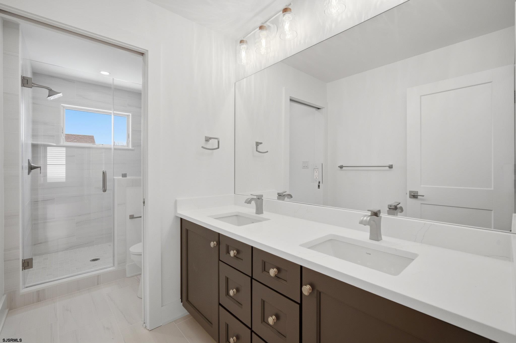 230 7th Street South Brigantine, NJ 08203 - Photo 23 of 87 a bathroom with double sink and a shower